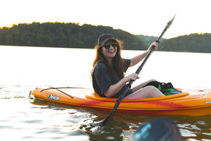 A woman paddling with a smile on face all about Noze reef-safe sunscreen oil. The oil-free, non-comedogenic (meaning it doesn't clog/block pores) formula features 100 percent zinc oxide and dries down to an invisible, matte, and non-greasy finish. 